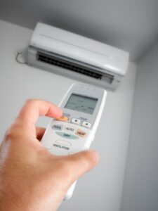 ductless-system-being-turned-on-by-hand-with-remote