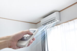 hand-holding-remote-to-turn-on-ductless-air-handler